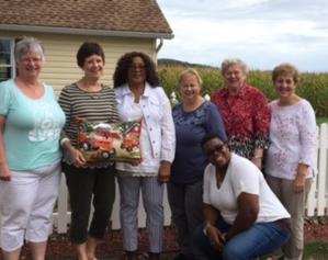 Pat Baldwin, Connie Ray, Evadne Morrison-Taylor, Linda Rabbach, Marty Karow, Nancy Gibbs and kneeling is Rev Nasal Ephraim